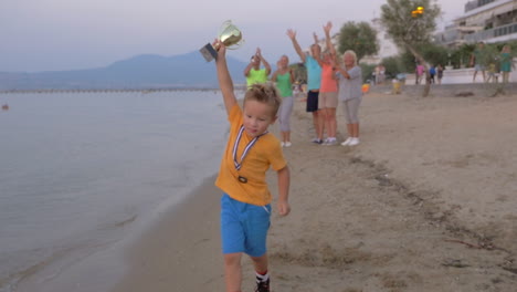 family members applauding to little champion boy