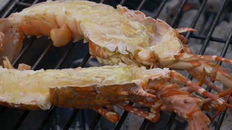 Thailand-street-restaurant-booth-grilled-lobster-on-charcoal-fire-halved-red-golden-with-cheese-coating