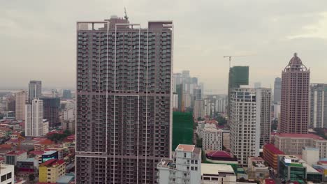 drone view over the city of phnom penh, morning light and cloudy with haze in the background