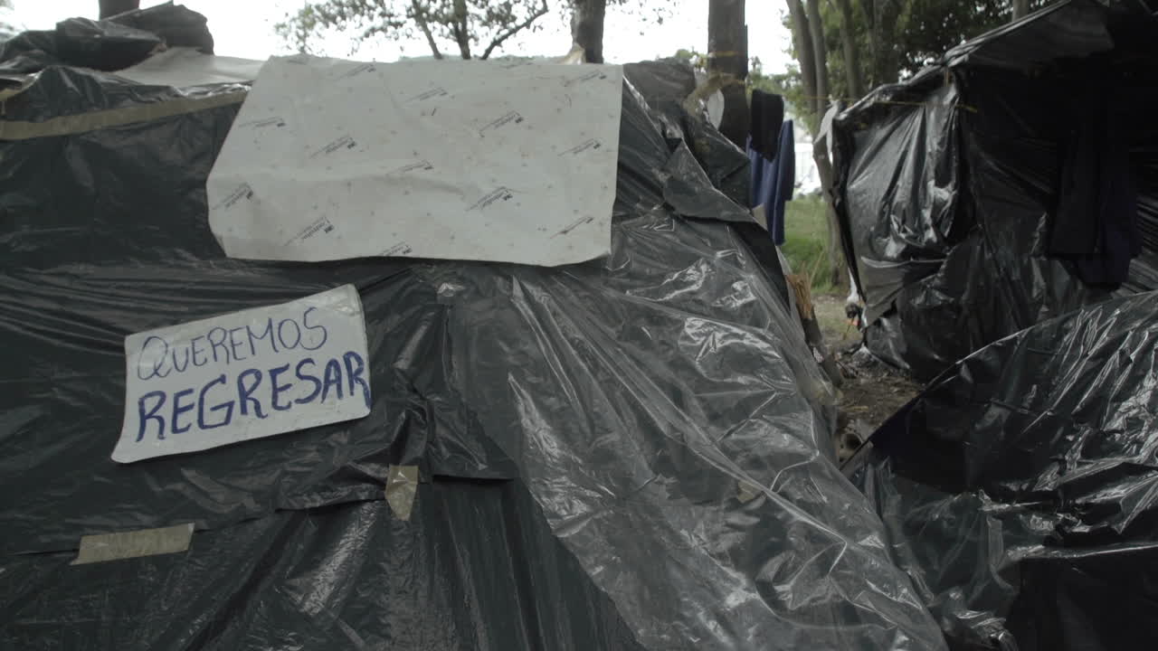 We want to go back! Sign at Venezuelan migrant camp. Because of the covid-19 crisis many migrants in Colombia try to return to their country. They lost their jobs and cant pay rent.
