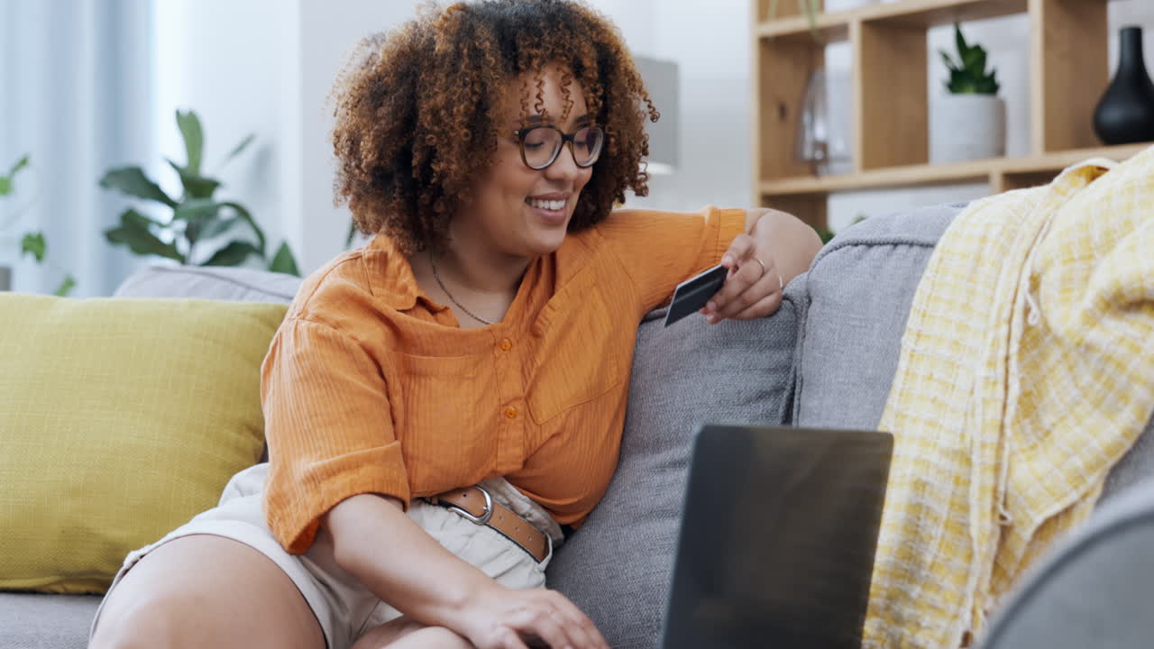 Couch, laptop and woman with credit card