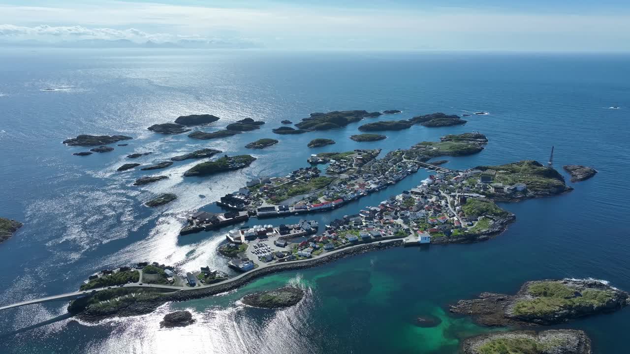 Henningsvaer with islands, turquoise shallows, and sunlit sea far out on Norway exposed coast