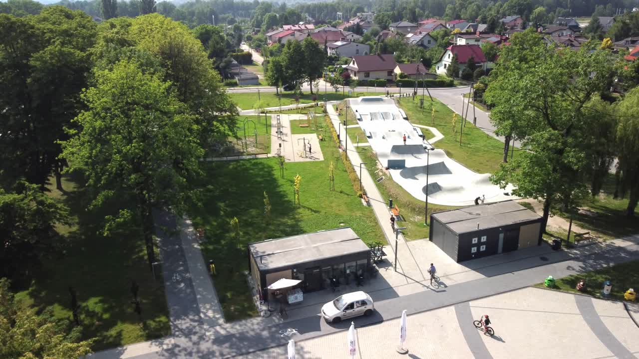 Young People Biking And Skating At Skatepark On Sunny Day In Krakow, Poland