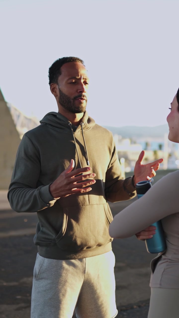 Active Couple Talking and Relaxing After Workout Outdoors