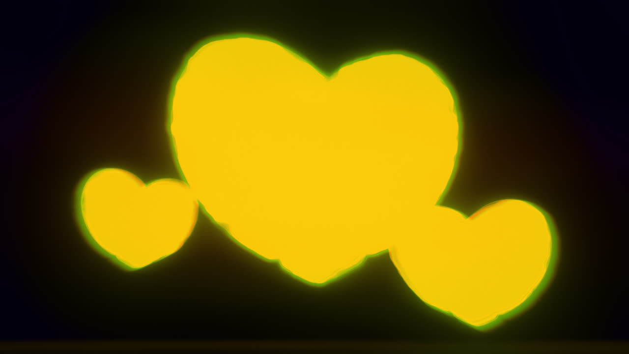 Yellow energy heart shapes on a dark background
