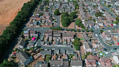 aerial footage of the small suffolk village of acton surrounded by farmland and golden fields-1