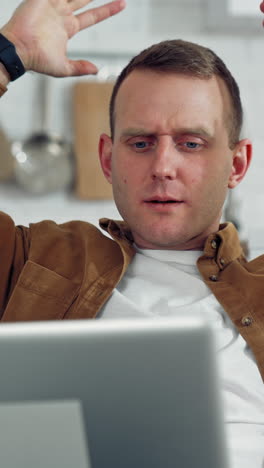 Handsome Man Using Laptop Computer. Young man with laptop computer working at home office