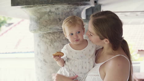 mother with baby holding cookie