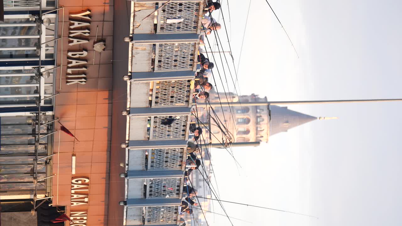 People fishing from Galata Bridge with Galata Tower in the background, Istanbul