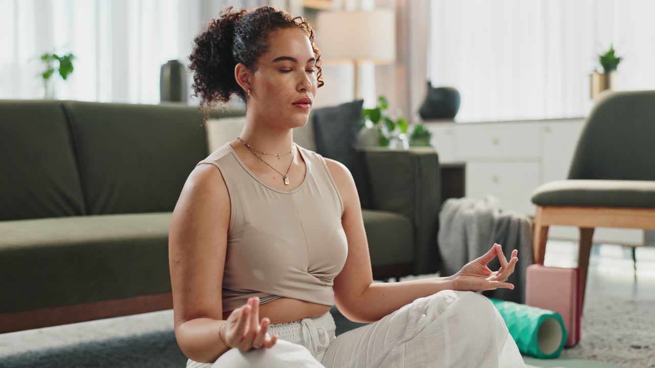 Woman practicing yoga and meditation at home