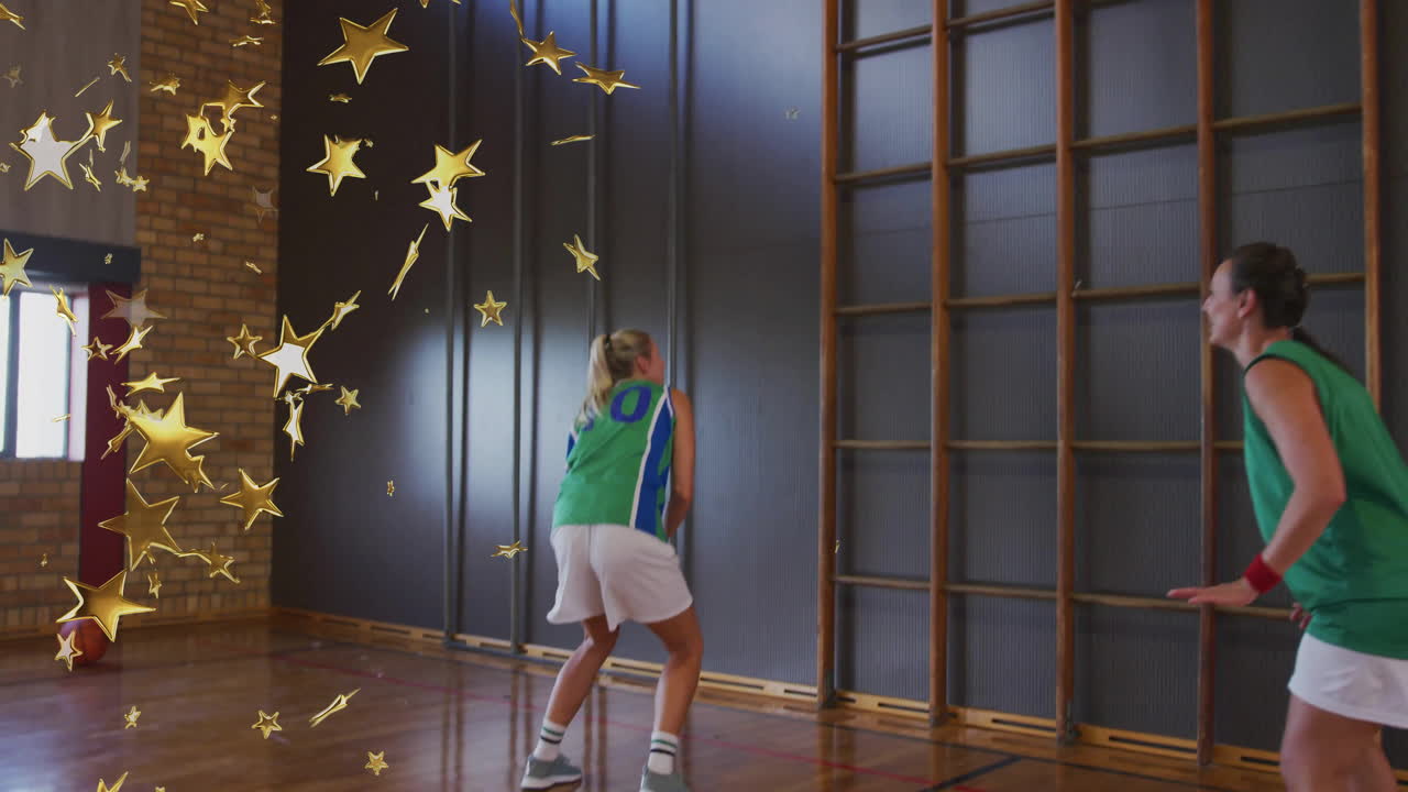 two female basketball players practicing jump shot in education gym with animated gold star overlay