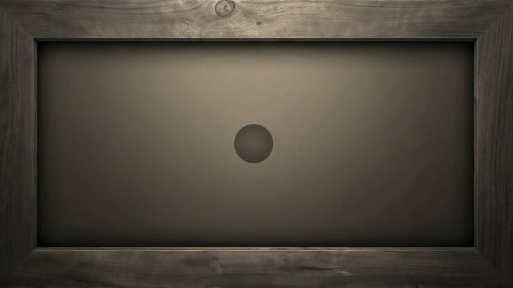 Brightening spotlight, dark matte sphere growing toward viewer in wood frame recess for display