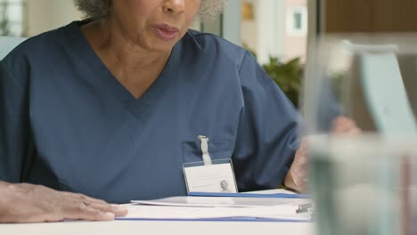 Mid-Section-Two-Doctors-in-Discussion-In-Office