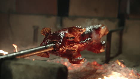 spit-roasted pork being cooked on the fire