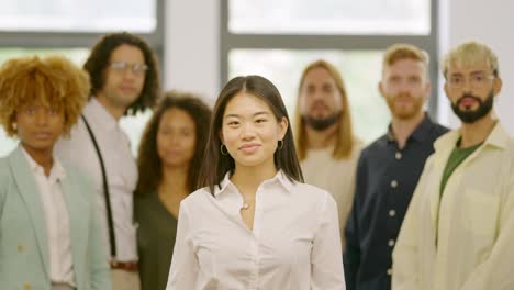 chinese woman leading a work team in the office