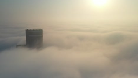 tower piercing the mist at sunrise