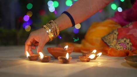 a women lighting a lamp