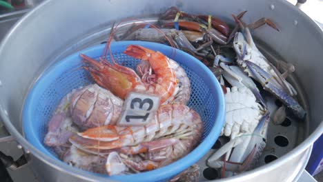 cooking-seafood-in-huge-steamer-closing-lid-mantis-shrimp-black-tiger-shrimp-blue-crab-mud-crab