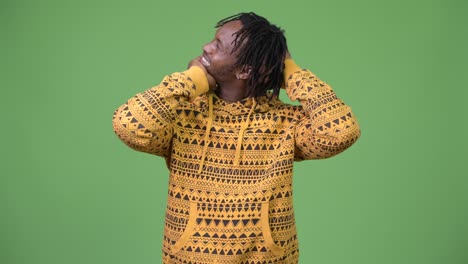 young handsome african man having neck pain and cracking neck