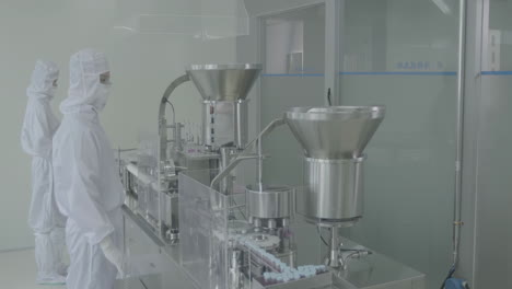sterile environment industrial pharmaceutical factory, a skilled workforce of scientists, and technicians collaborates to oversee and maintain the automated production lines