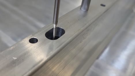 cmm coordinate measuring machine - checking the size and location of a slot on a machined aluminum part close up stationary camera
