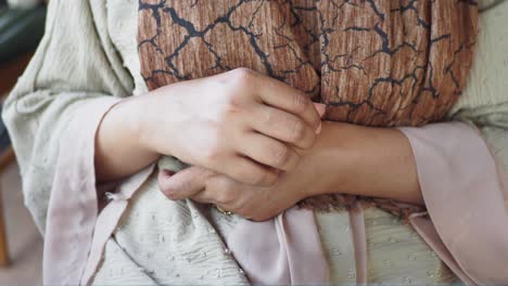 close up of a woman's hands clasped together