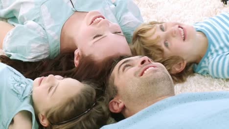 family lying on the ground looking at camera