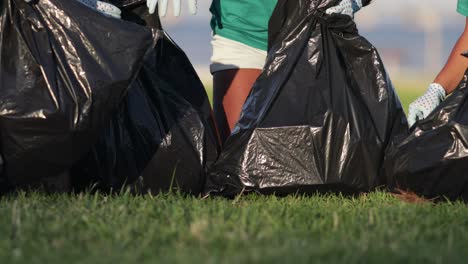 volunteers picking garbage in bags