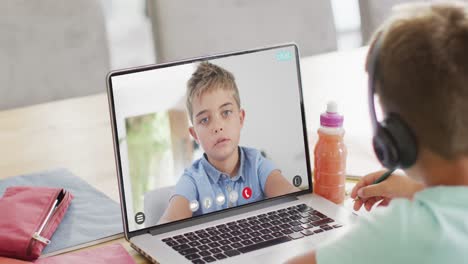 Composition-of-caucasian-schoolboy-on-laptop-online-learning-with-caucasian-schoolboy