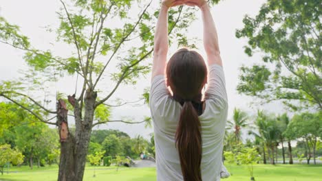 woman stretching outdoors in park