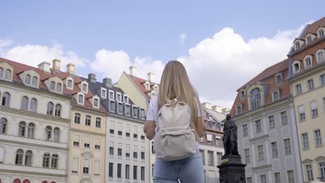 a traveler finds joy and admiration while exploring the stunning historic buildings in a lovely european square
