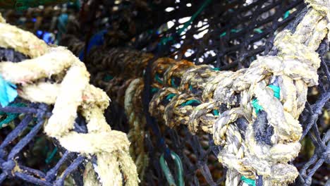 stacked empty fishing industry lobster net baskets closeup dolly left