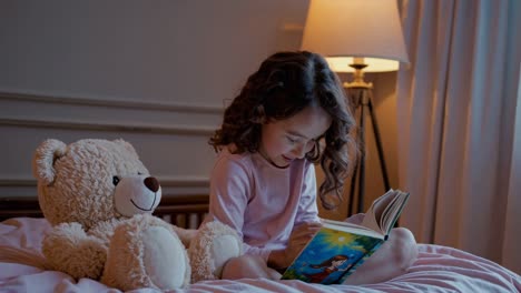 little girl reading bedtime story