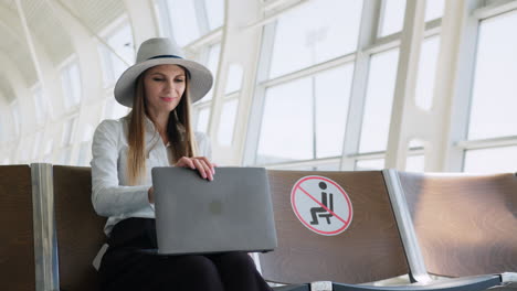 woman working on laptop at airport