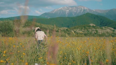 little girl picks wildflowers