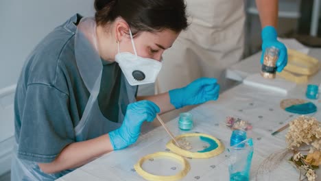 woman creating resin crafts
