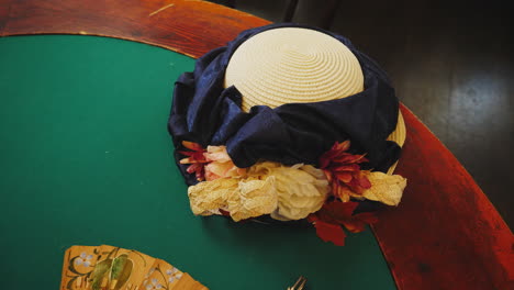 vintage woman's straw hat on a green table