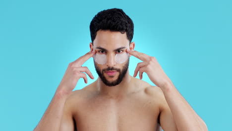 face, eye patches and skincare of man in studio