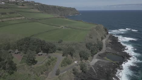 Coastal-road-and-volcanic-rocky-cliffs-of-Santo-Antonio,-Sao-Miguel-of-Azores-islands