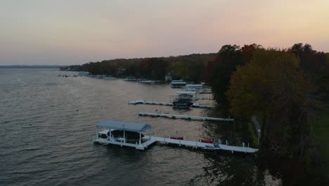 static aerial establishing shot of lake and boat dock at sunset