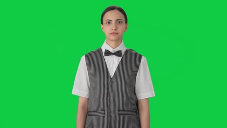 Serious-Indian-woman-waiter-looking-Green-screen