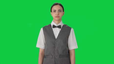 serious indian woman waiter looking green screen