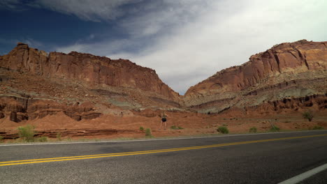 woman looking at desert rocks in utah on summer vacation