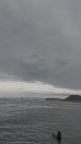 surfers in a cloudy ocean scene