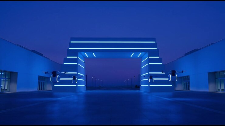 Droni futuristici che volteggiano accanto a un arco illuminato al neon di notte