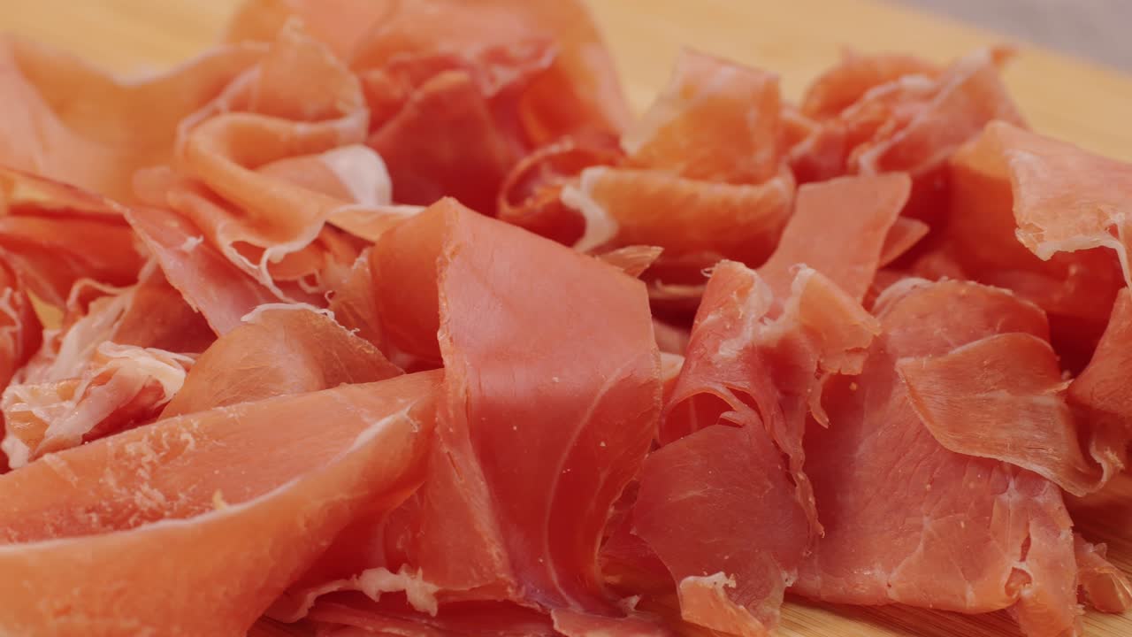 Slices of Prosciutto on a Wooden Board