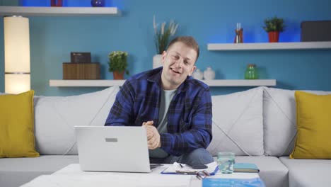 Home-office-worker-man-looking-smugly-at-camera.