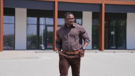 handsome businessman walking outside. portrait of confident man looking away in stylish suit at street