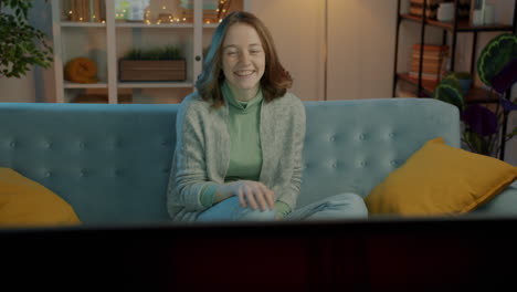 woman watching tv at home