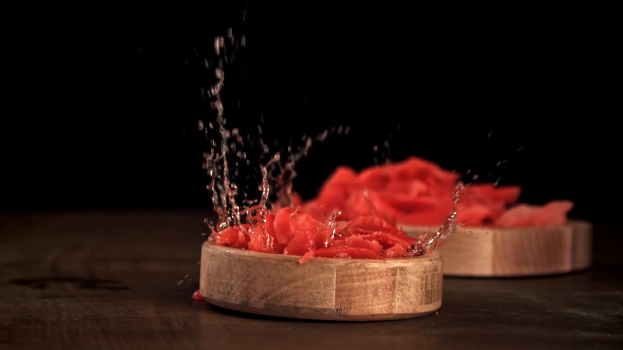 Slow Motion Pickled Ginger Splashing in Wooden Bowl